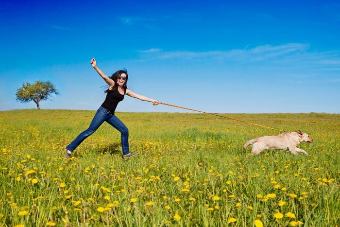 mujer siendo arrastrada por un perro que usa un collar super resistente